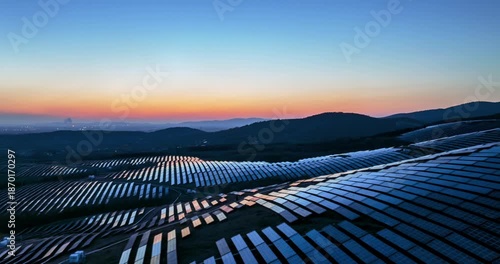 Wallpaper Mural Aerial time-lapse of solar power station on rolling hills during twilight, renewable energy landscape in blue hour Torontodigital.ca