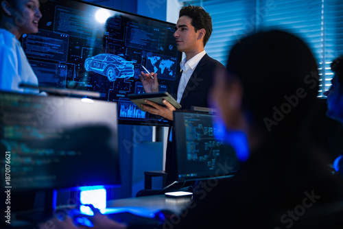 Industrial design team planning future transport strategy. Executive presenting new smart mobility concept and market trend analysis on digital board during late night workshop.