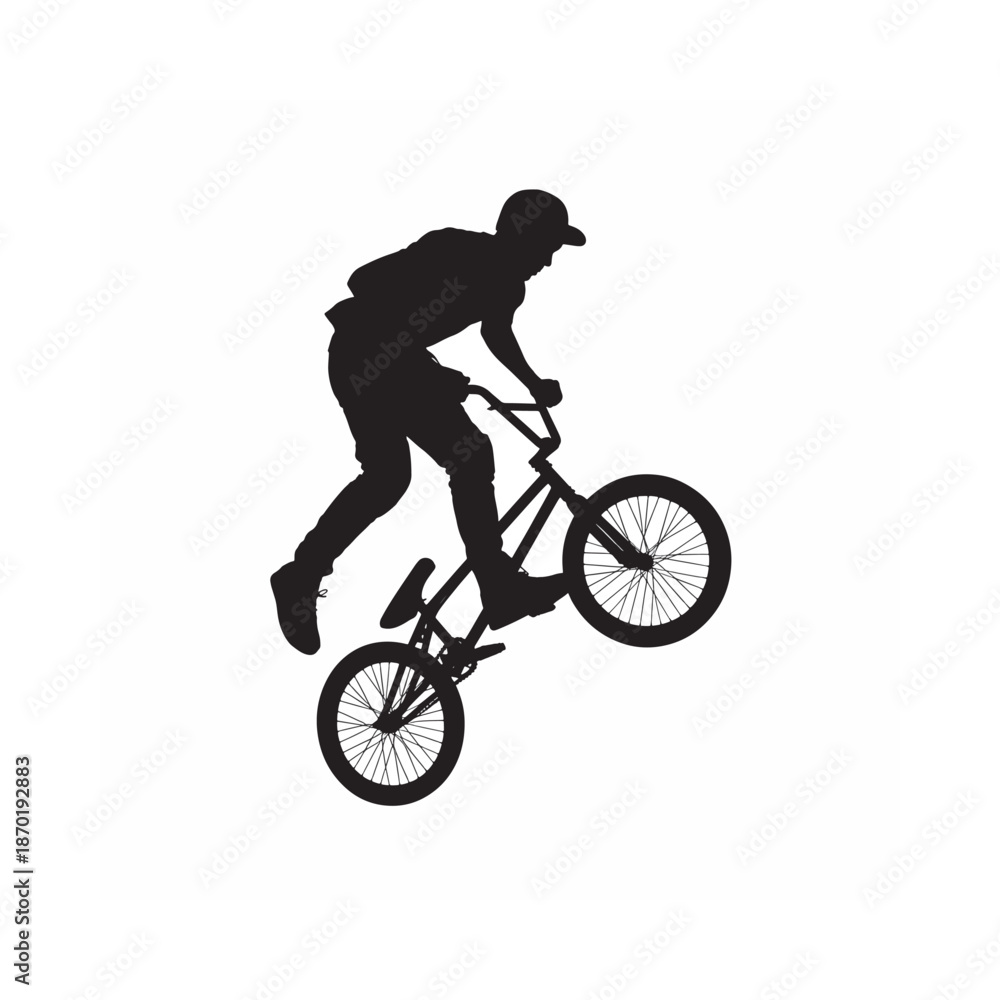 Fototapeta premium Silhouette of a biker performing a wheelie on a bmx bike dynamic action pose