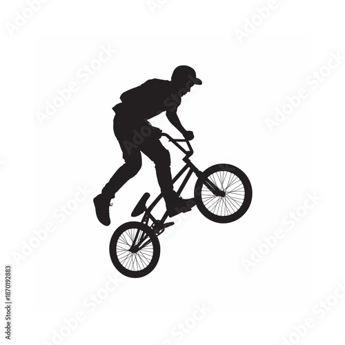 Silhouette of a biker performing a wheelie on a bmx bike dynamic action pose
