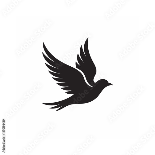 A striking black silhouette of a bird in flight wings gracefully spread and soaring