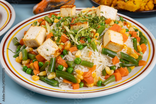 A plate of vegetable pulao, Indian rice, with fried chunks of tofu