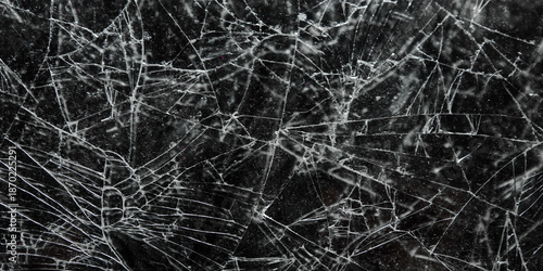 Cracked and shattered black glass screen background texture