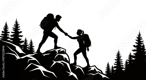 Silhouette of two hikers helping each other while climbing rocky mountain in forest landscape.