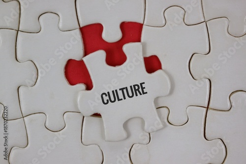 A white jigsaw background with a single puzzle piece labeled CULTURE resting on an red underlay.