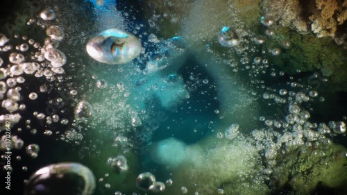 Underwater Scene with Rising Bubbles and Rocks.
