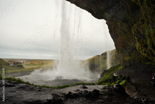 Принти на полотні Majestic Seljalandsfoss waterfall in Iceland, where powerful cascades of crystal-clear water plunge from towering cliffs into a misty pool below