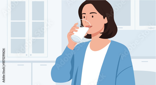 A Young Woman Enjoying a Refreshing Glass of Milk in a Bright, Modern Kitchen Setting