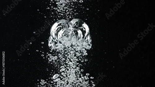 Rising water bubbles erupting against a dark black void background.