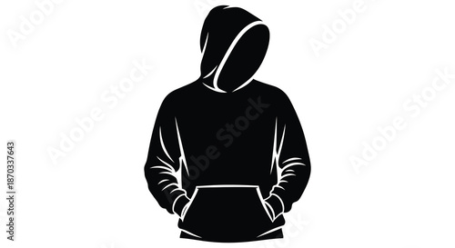 A dark hooded figure standing with hands in pockets a striking black silhouette