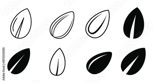 A collection of seed shapes in varying orientations presented as a black silhouette