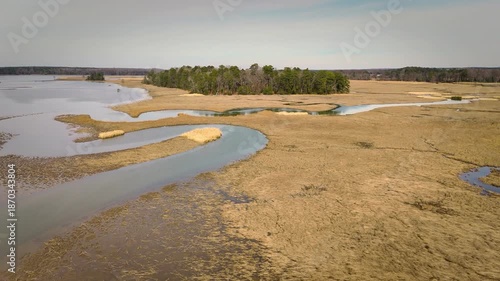 Aerial shot over calm Chickahominy River with marshland and horizon glow, Virginia