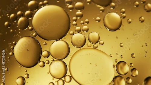 Golden Serum Drop and Oil Bubbles Floating in Liquid Macro Background