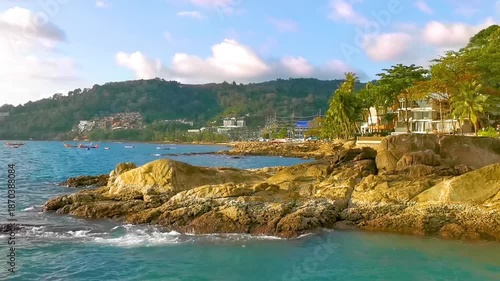 Kalim Beach tropical panorama view rocks sea palms Phuket Thailand.