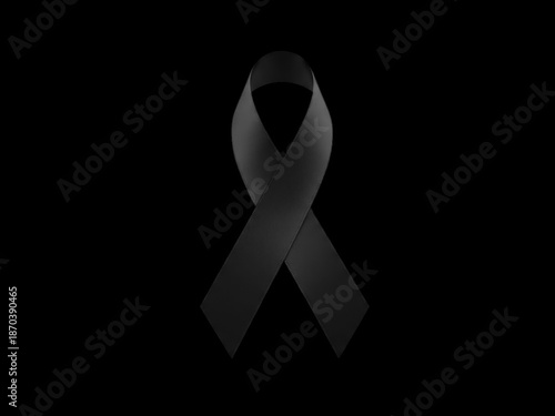 Symbol of mourning and remembrance, a black awareness ribbon isolated on a solid black background representing loss, grief, or support for a cause