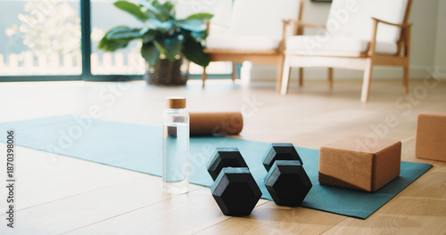 Foto House, mat and dumbbells with glass bottle for fitness training, exercise equipment and workout gear