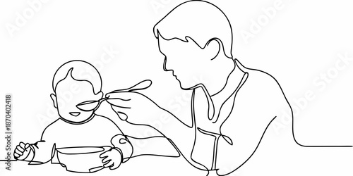 A father lovingly feeds his young child with a spoon at the table