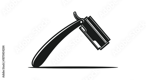A vintage straight razor with a classic design casting a dramatic shadow silhouette