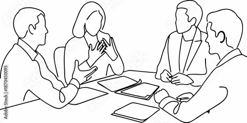 A business meeting in progress with four people seated around a table