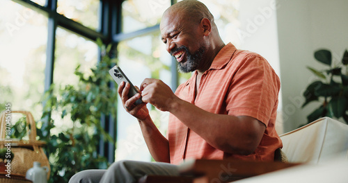 Bild auf Leinwand Lounge, reading or happy man with phone in home, internet search or scroll social media from low angle