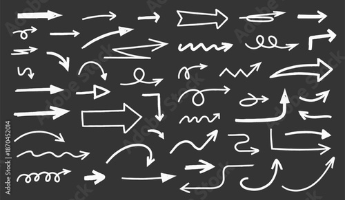 Hand drawn chalk sketched arrows of different shapes and directions on black background
