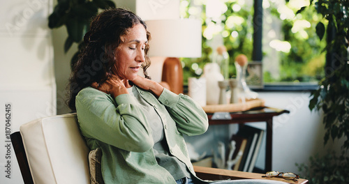 Neck pain, headache and stress with woman in living room of home for burnout, discomfort or fatigue. Brain fog, dizzy and muscle massage with mature person in apartment for recovery or symptom relief