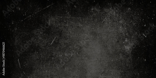 A dark and grainy texture displays a damaged or aged film effect with subtle scratches and dust particles