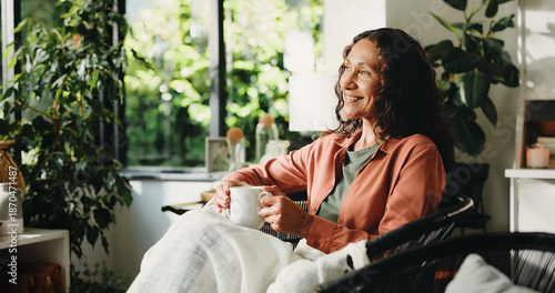 Photography Home, thinking and woman with coffee, relax and reflection with memory, smile and comfort in lounge