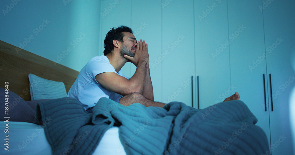 Fototapeta premium Frustrated, night and man in bedroom with insomnia for burnout, exhausted and fatigue for mental health. Tired, dark and person with upset, sad and anxiety for sleepless, bad dream and stress in home