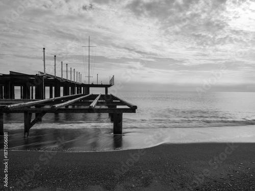 serene sunset scene with an old pier and calm sea