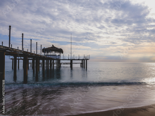 serene sunset scene with an old pier and calm sea