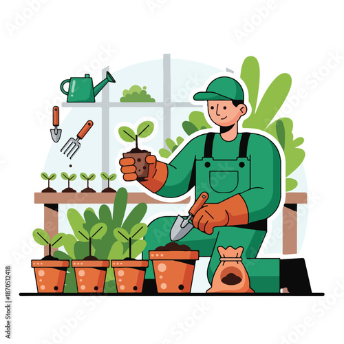 A gardener in green overalls holding a plant