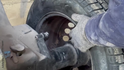 Mechanic replacing a car tire on a tire changing machine