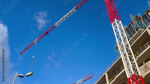Tower crane lifting a container on a construction site