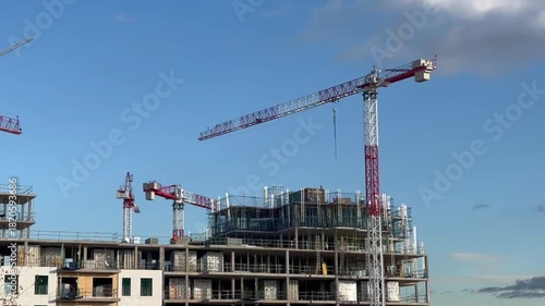 Tower cranes operating on a building construction site