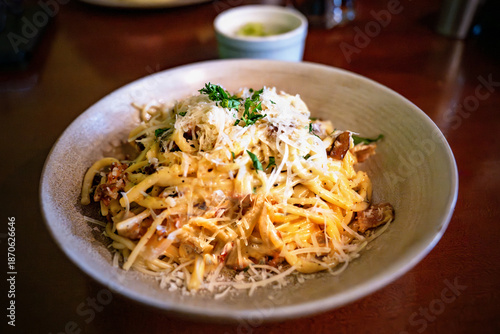 Spaghetti carbonara with bacon and grated cheese, herb.