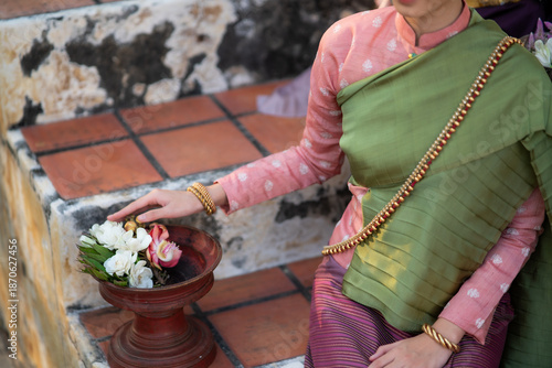 Detail of traditional Lanna costume and floral offering in northern Thai culture
