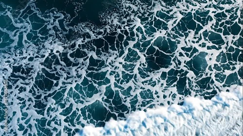 Aerial View Of Ocean Waves Crashing With White Foam