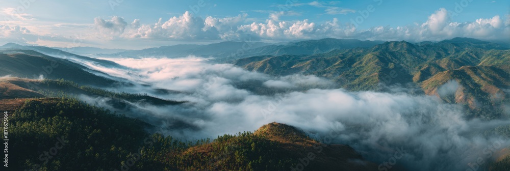 Fototapeta premium Mountain peaks above clouds during sunrise