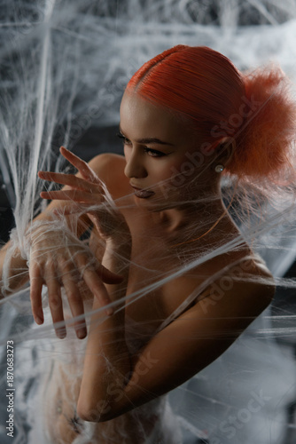 Wallpaper Mural Red-haired woman entangled in a net trap amid a dramatic backdrop Torontodigital.ca