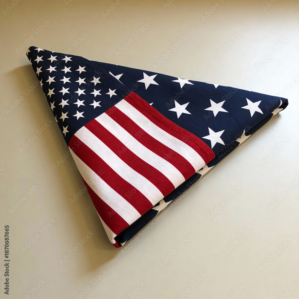 Obraz premium American flag folded in triangular shape resting on flat surface 