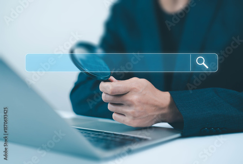 Bilde på lerret Businessman holding magnifying glass with search bar interface, online search and investigation concept, data research, SEO analysis, information discovery and digital business technology background