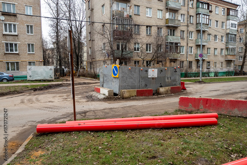 Laying red pre-insulated pipes on the sidewalk during urban construction work . Road works. Modernization of public utilities