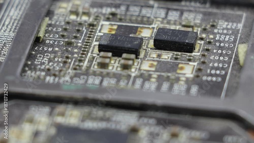 Close-up of an old dusty microchip or PC board, rotating to showcase its detailed and intricate components.