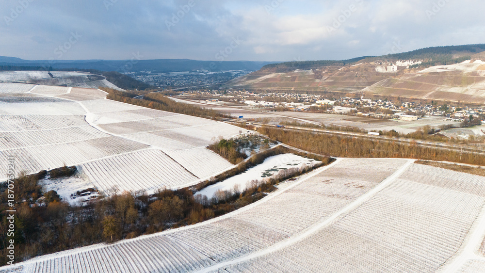 Fototapeta premium Moselle valley, winter season, snow and frost covered vineyard and river landscape near Trier, Germany, aerial view