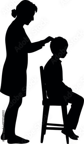 Mother combing her son's hair in a black silhouette