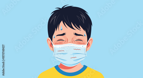 Sick young boy wearing a face mask while sweating and appearing feverish with red cheeks on a plain blue background.
