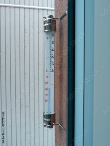 thermometer with Celsius units scale on window outdoors (-26 degrees)