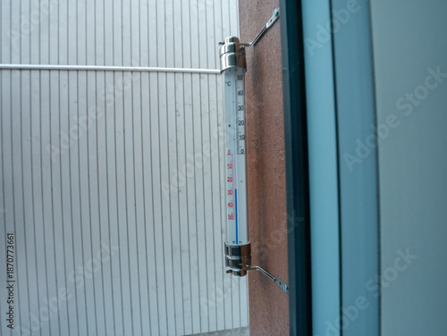 thermometer with Celsius units scale on window outdoors (-26 degrees)