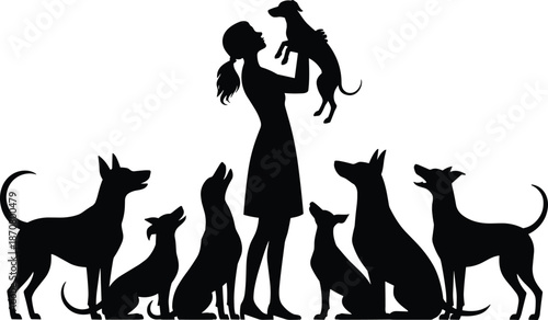 Silhouette of a woman holding a dog surrounded by various other dogs